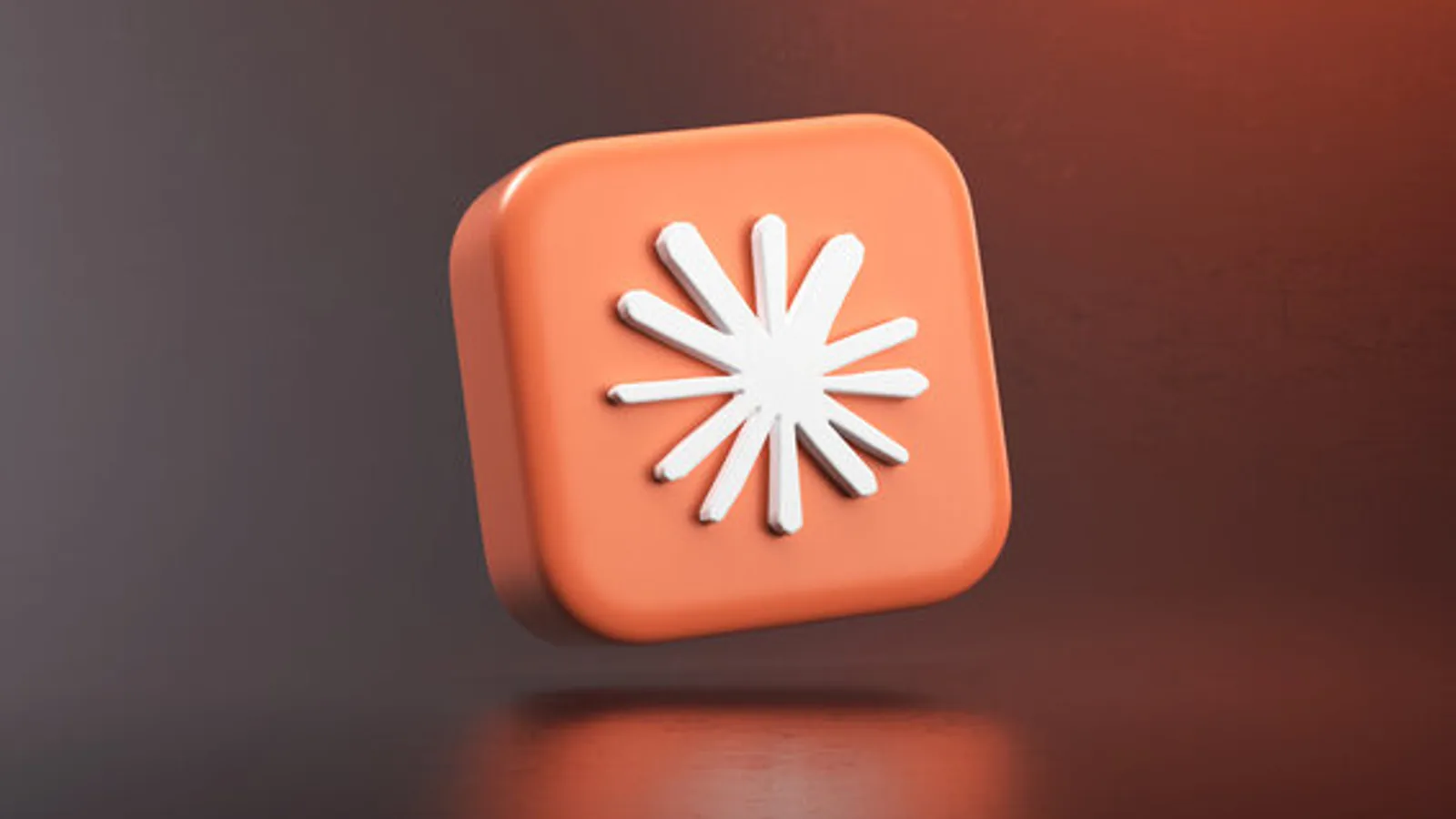 Le logo de Claude, une étoile blanche sur un carré orange en relief, sur un fond sombre aux reflets chauds